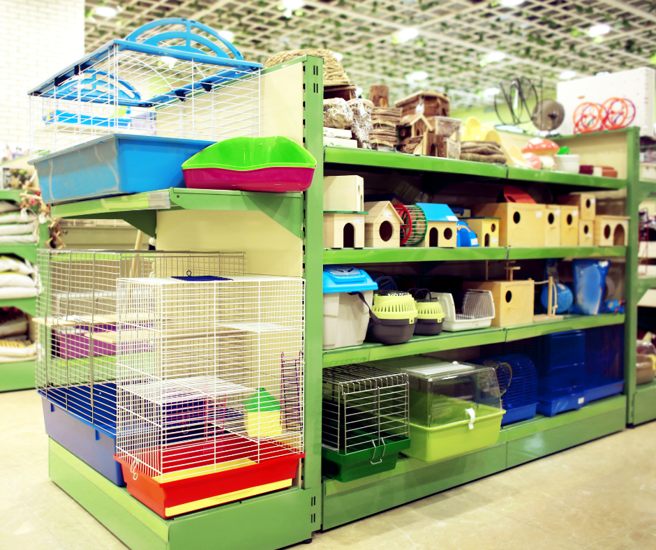 Small pet travel carriers and homes on display in pet shop.